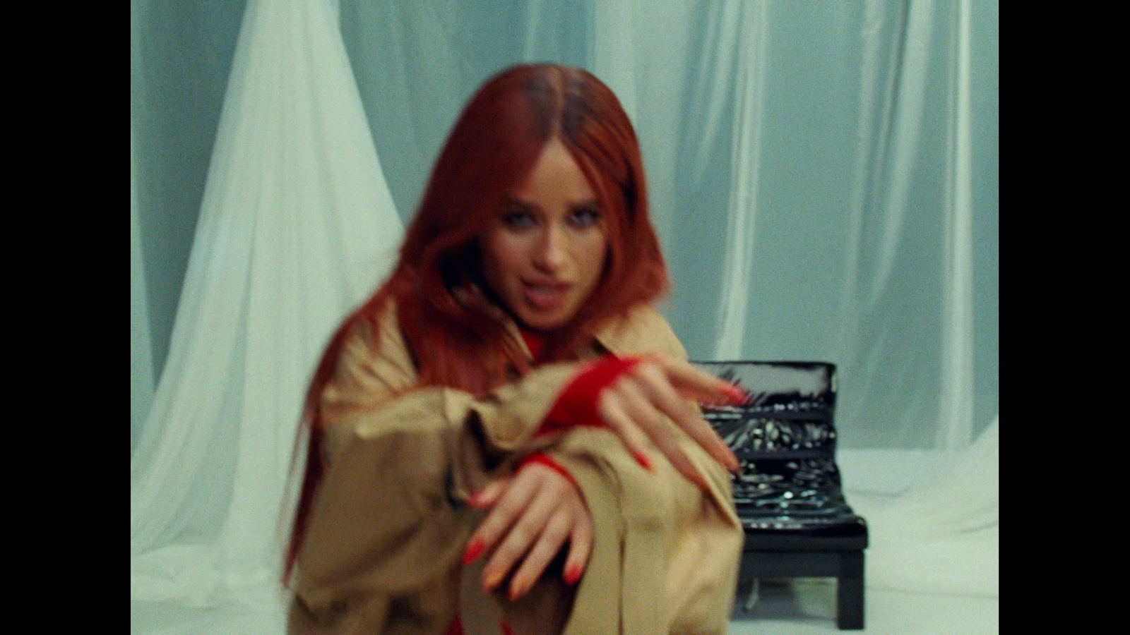 a woman with long red hair is sitting in front of a typewriter