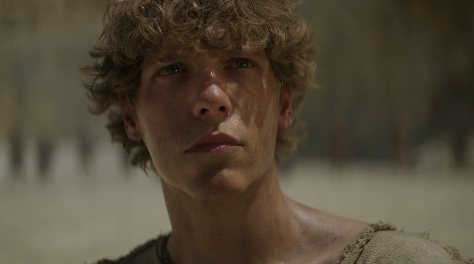 a close up of a person with curly hair