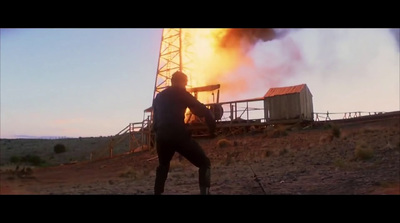 a man standing in front of a large fire