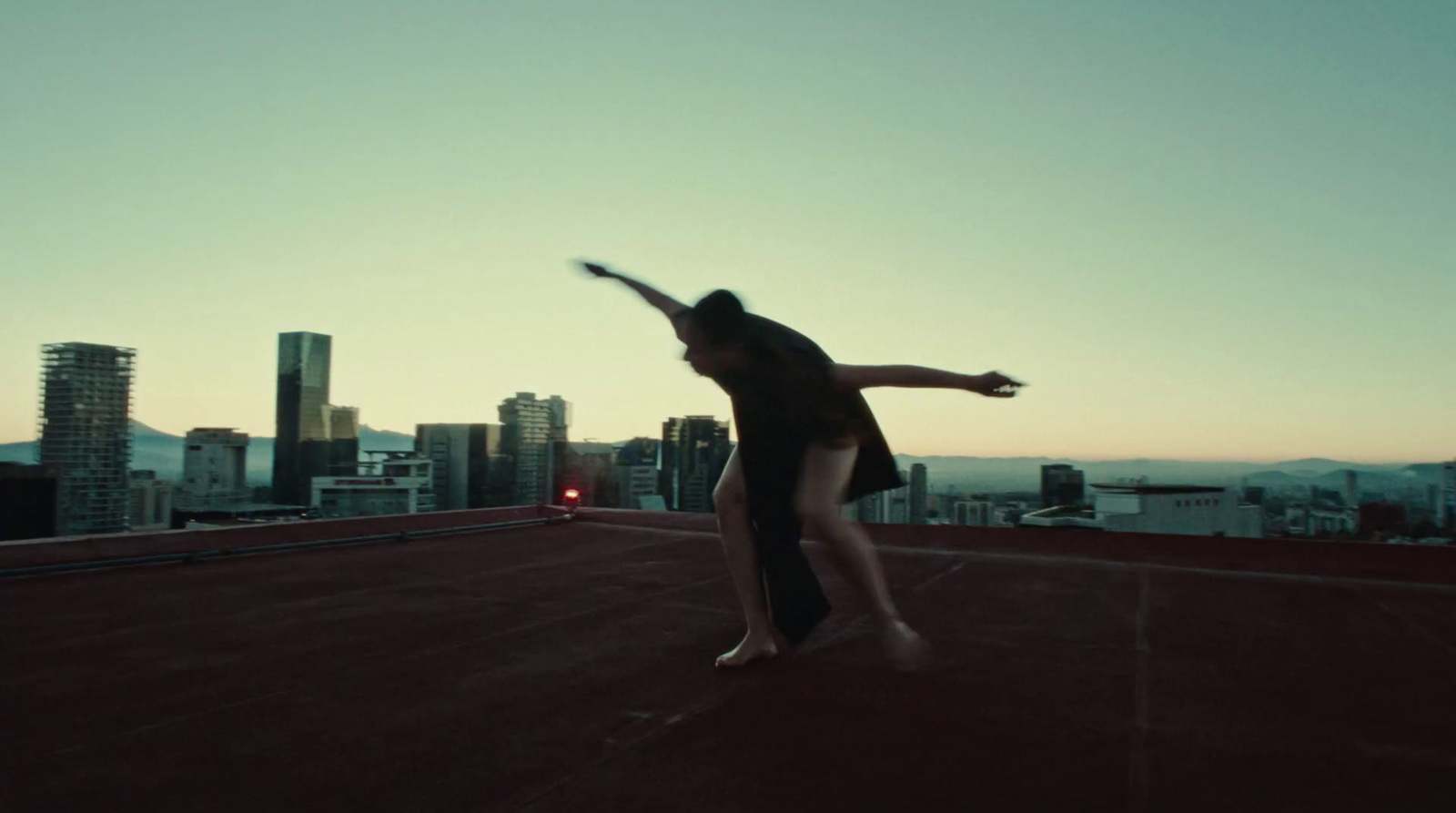 a person jumping in the air on a roof