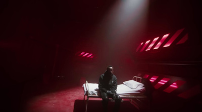 a man sitting on a bed in a dark room