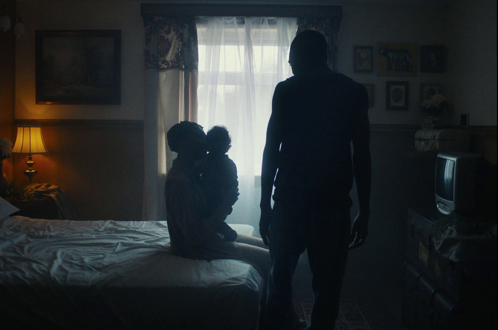 a man standing next to a woman in a bedroom