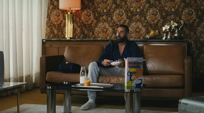 a man sitting on a couch in a living room