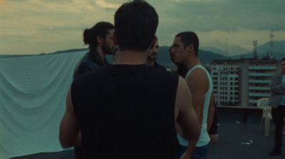 a group of men standing on top of a roof