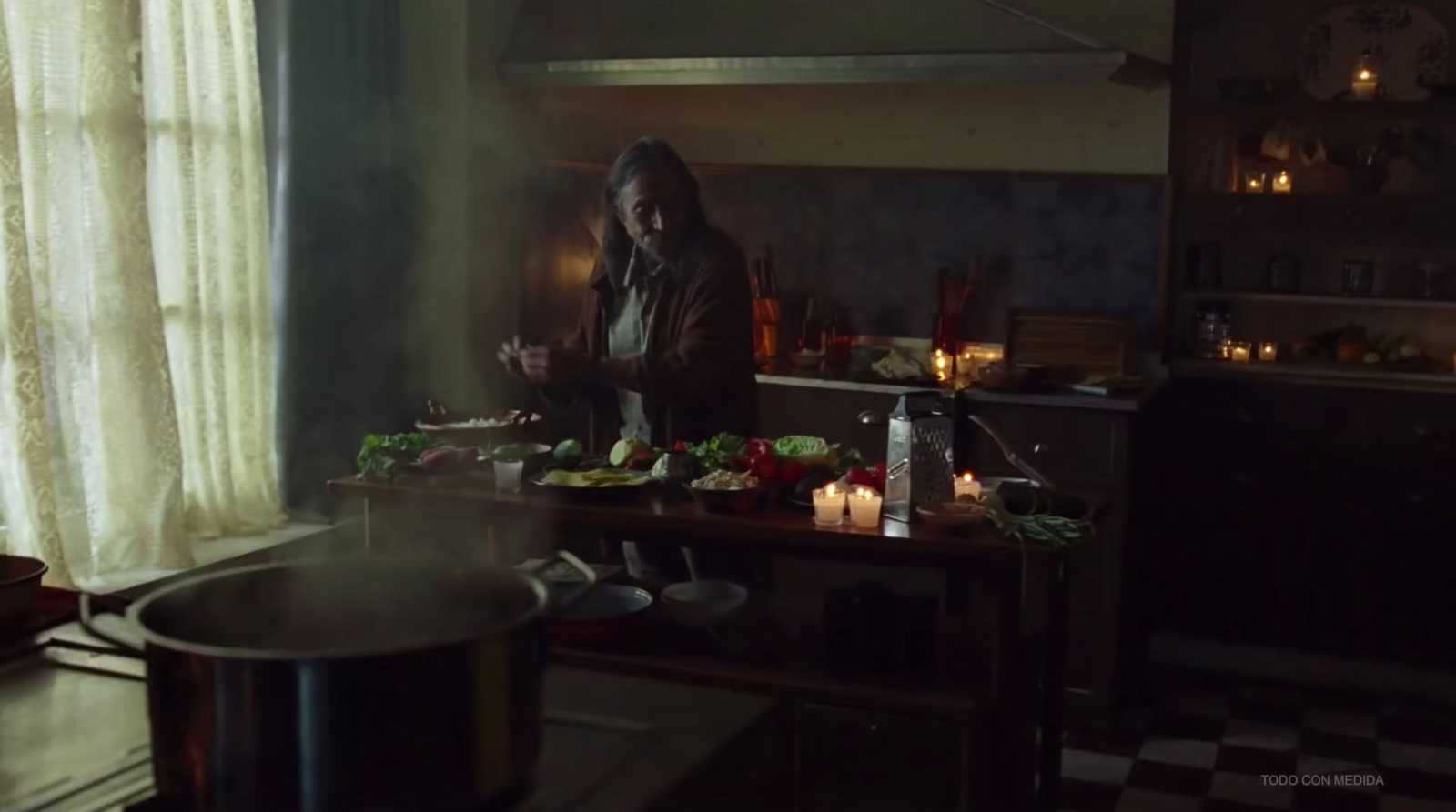 a woman standing in a kitchen preparing food