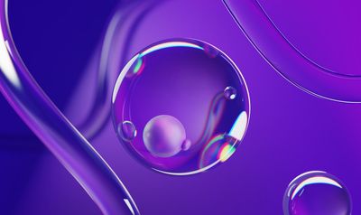 a close up of a liquid droplet on a purple background