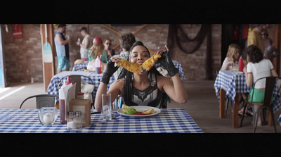 a woman sitting at a table with a plate of food