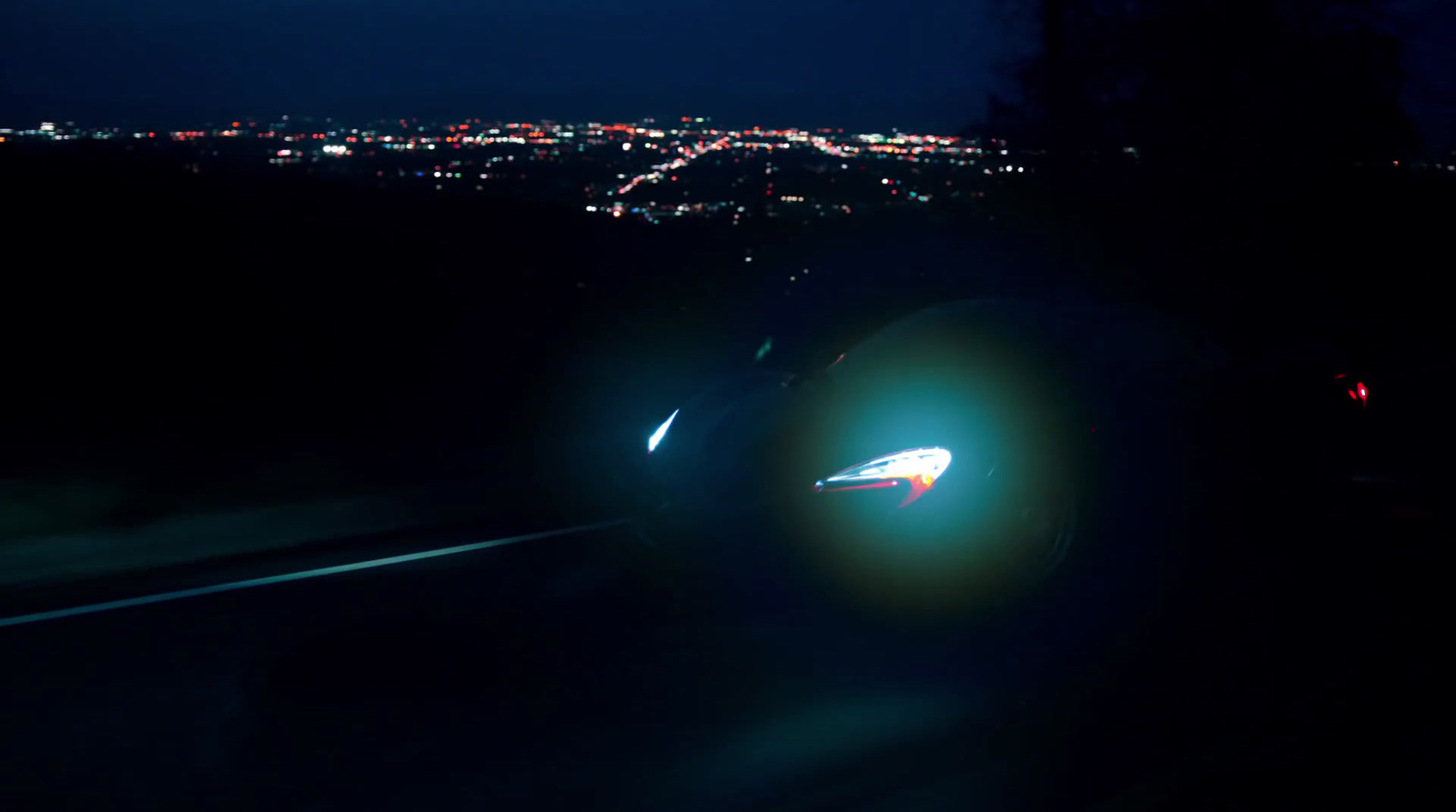 a car driving down a road at night