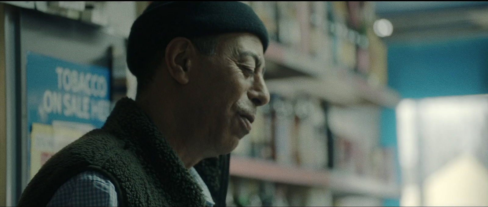 a man standing in front of a book shelf