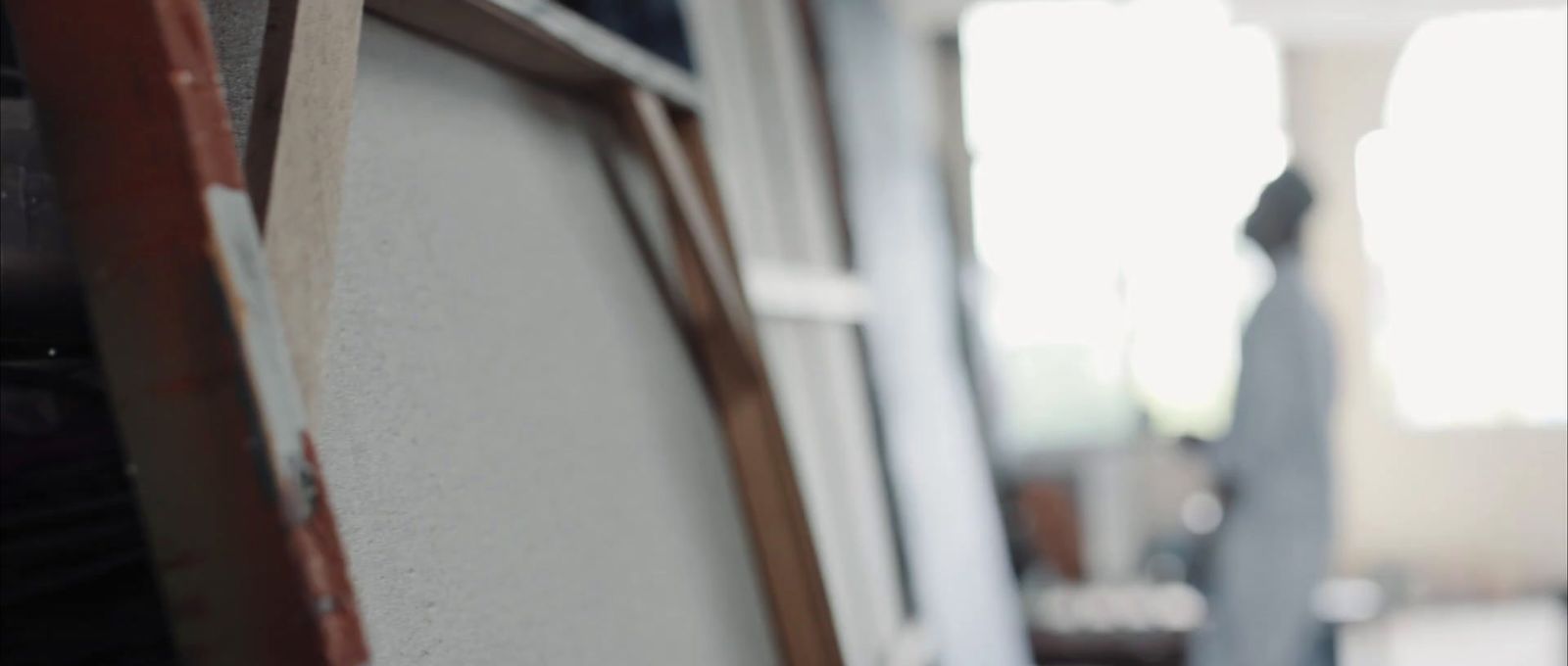 a close up of a window with a person in the background