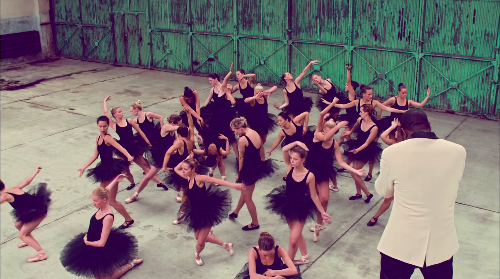 a group of dancers in black tutus and tutus