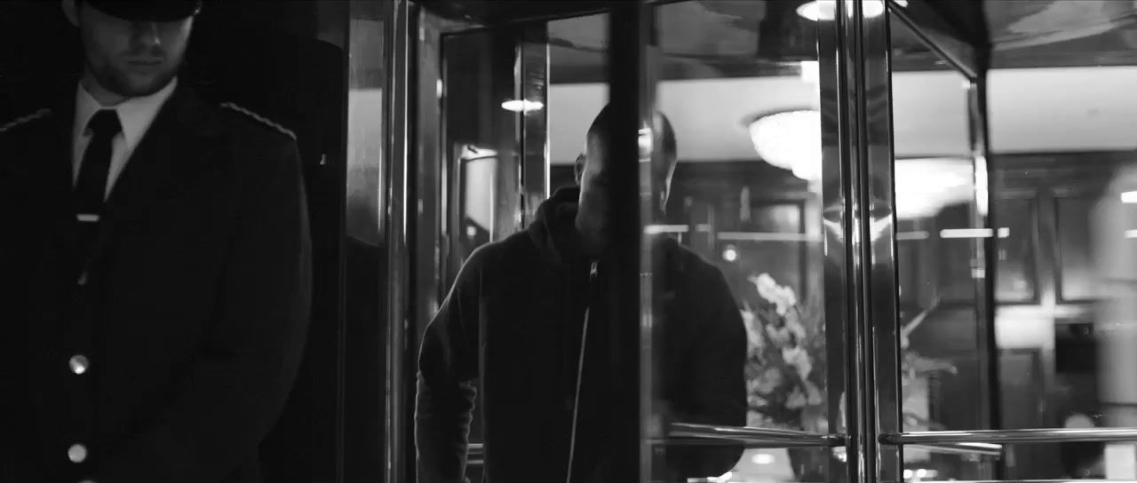 a man standing in front of a glass door