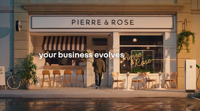 a man standing in front of a restaurant