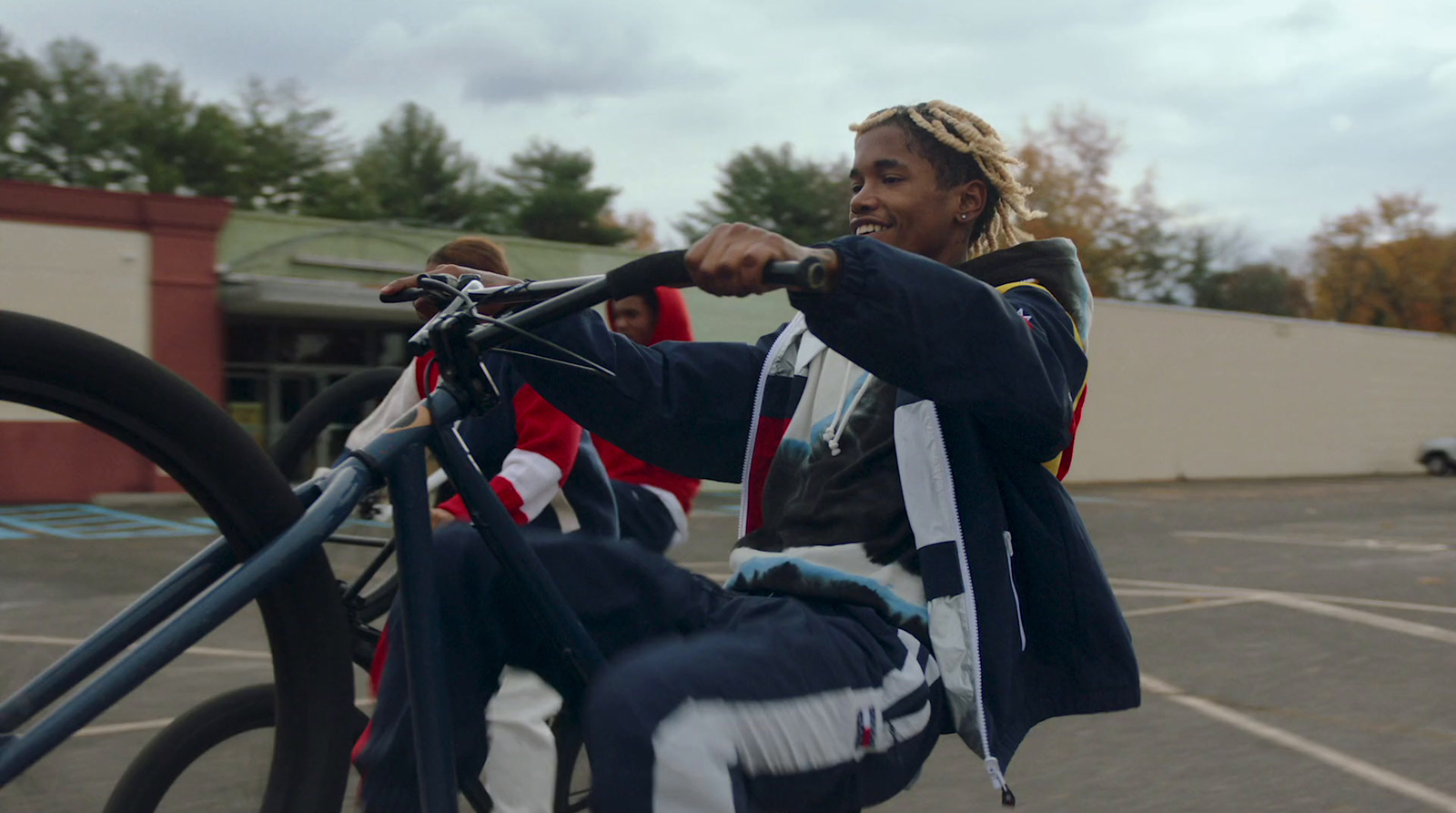 a woman riding a bike in a parking lot