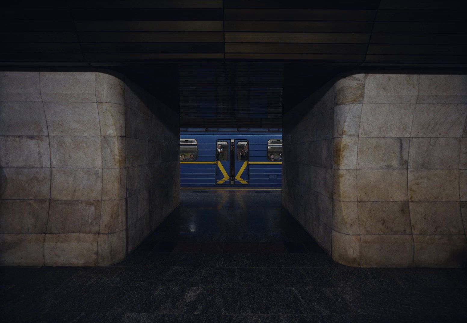 a subway train is coming out of a tunnel