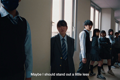 a group of young people standing in a hallway