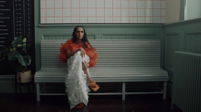 a woman sitting on a bench in a room