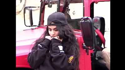 a woman standing in front of a red truck