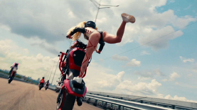 a woman riding on the back of a red motorcycle