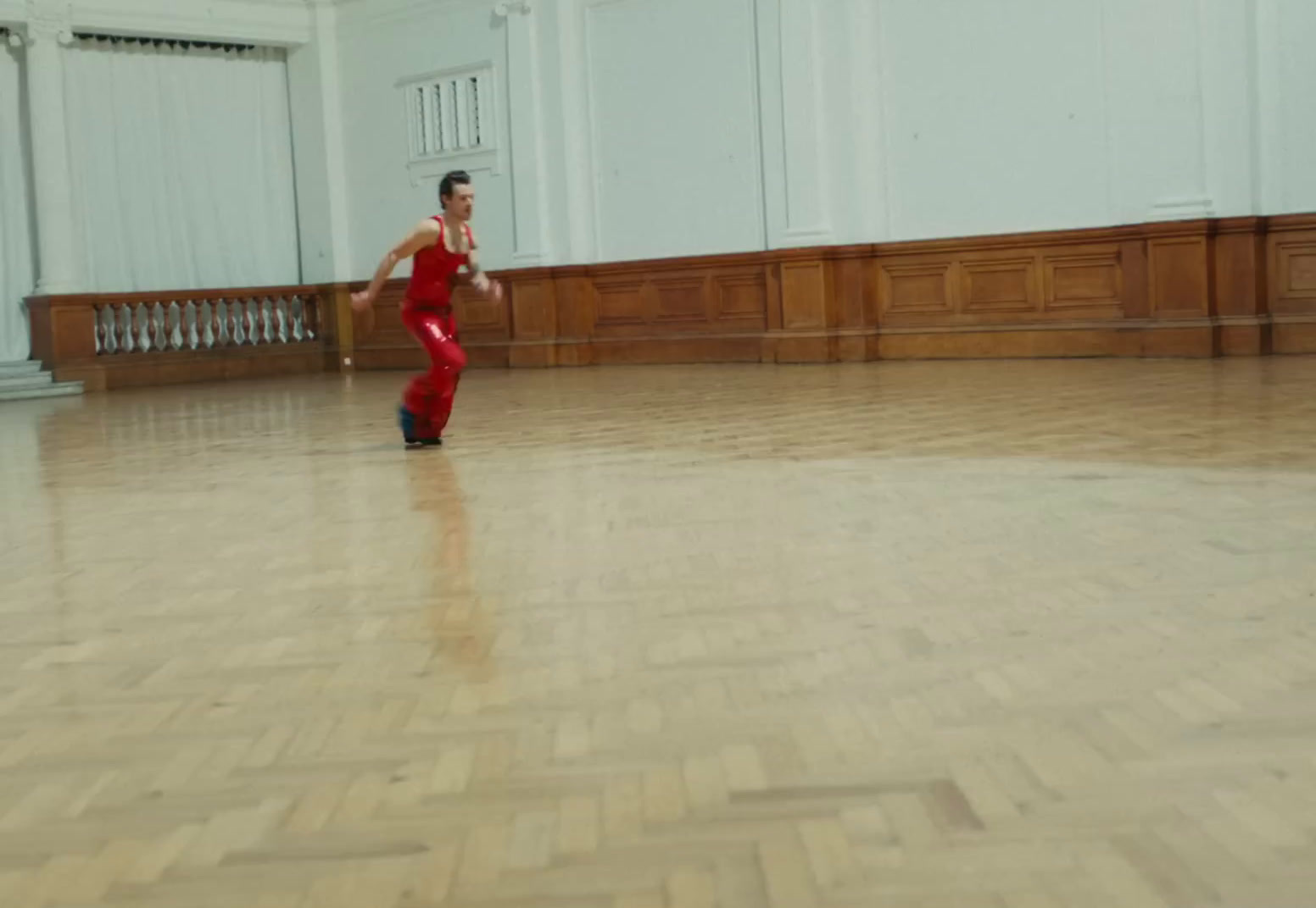 a person in a room with a wooden floor