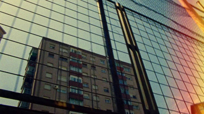 a tall building behind a wire fence