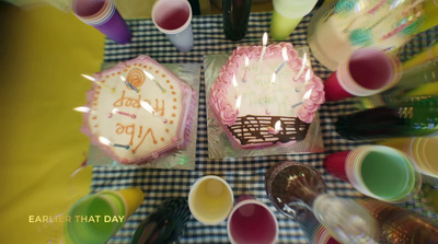 a table topped with two cakes covered in frosting