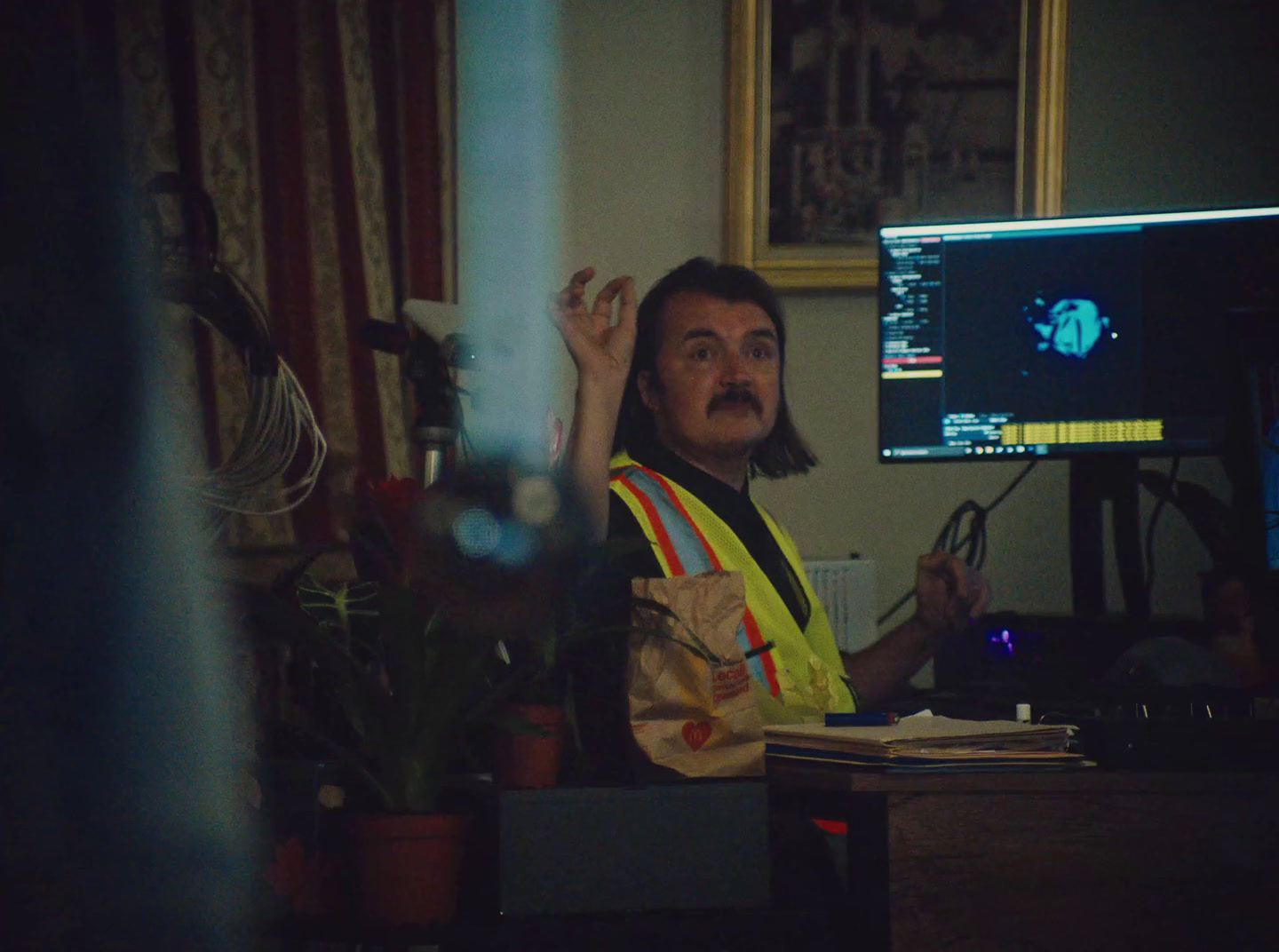 a man sitting at a desk in front of a computer