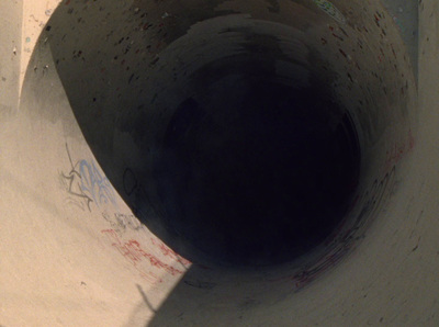 a close up of a toilet bowl with graffiti on it