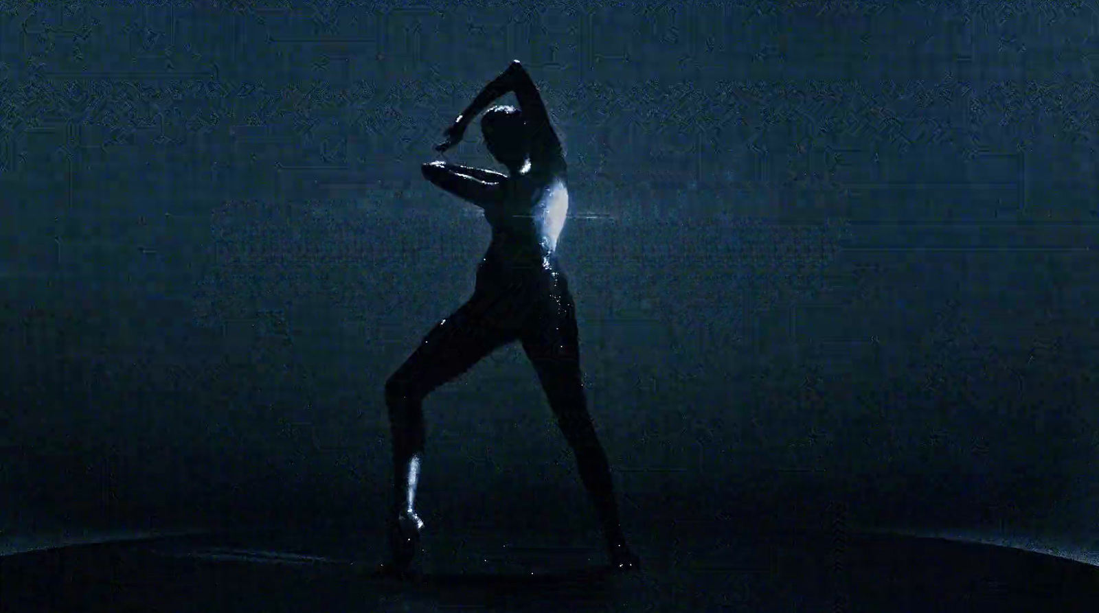 a woman in a bodysuit standing in the dark