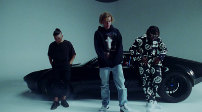 a group of people standing next to a car