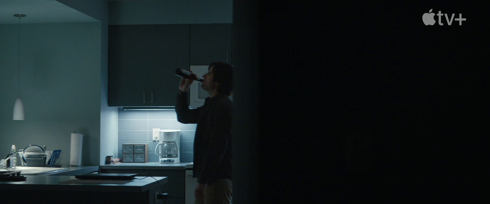 a woman standing in a kitchen next to an oven