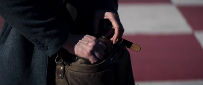 a person holding a knife in their pocket