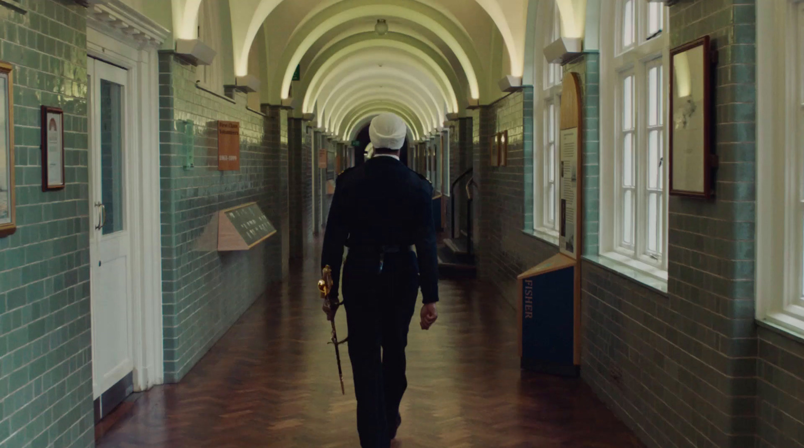 a man walking down a hallway in a building