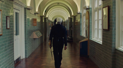 a man walking down a hallway in a building