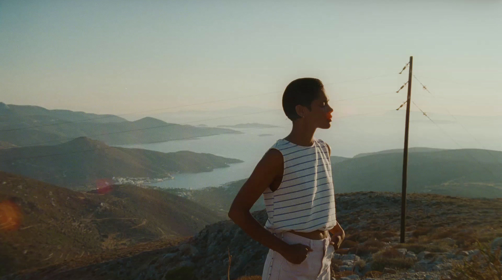 a young man standing on top of a mountain