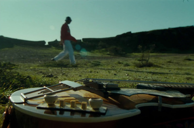 a man walking across a lush green field