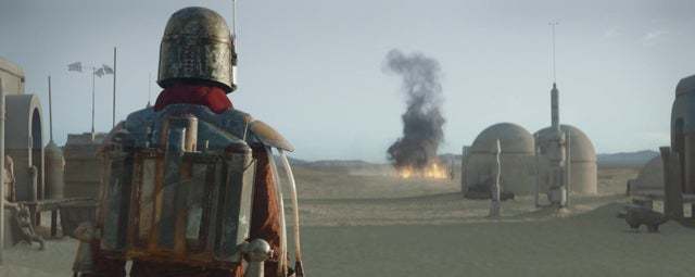 a man in armor standing in front of a building