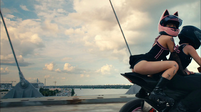 a woman sitting on a motorcycle with a helmet on