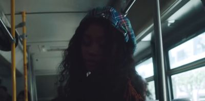 a woman with long hair riding a bus