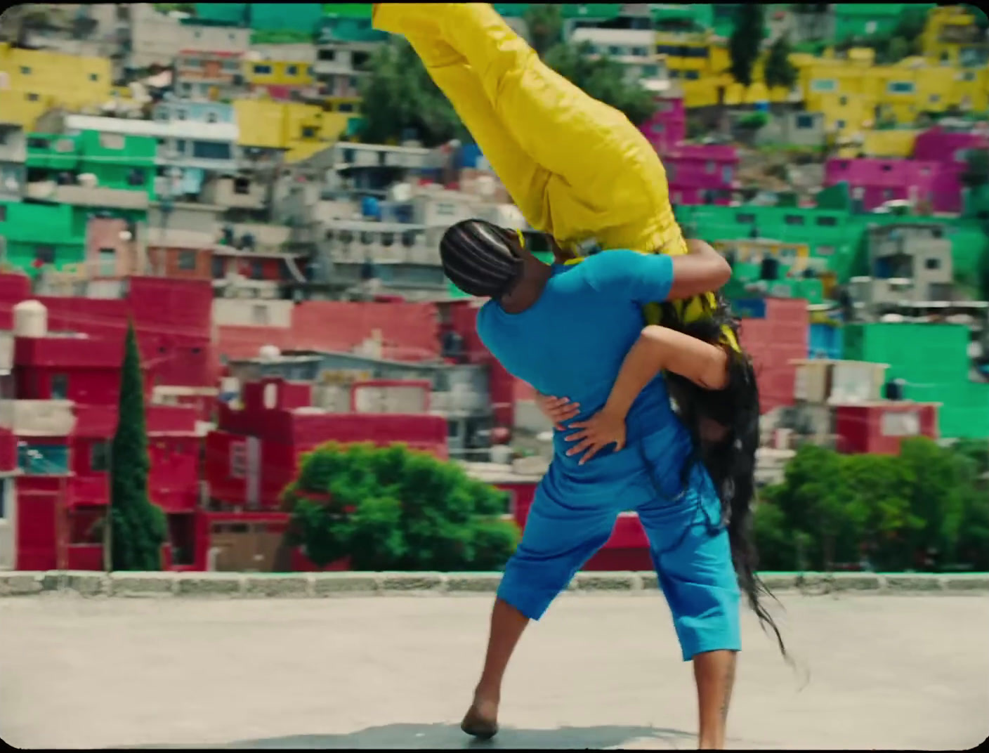 a man and a woman doing a handstand on a skateboard