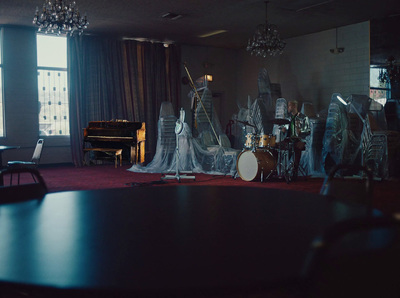 a room with a piano, a piano, and a set of musical instruments