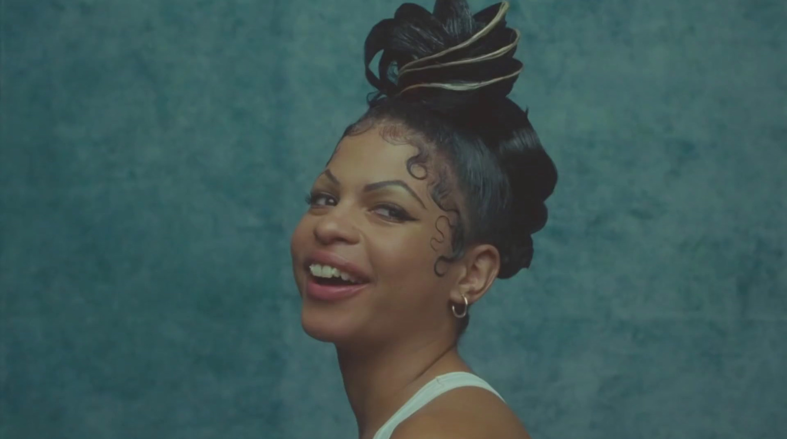 a woman with tattoos on her face smiling