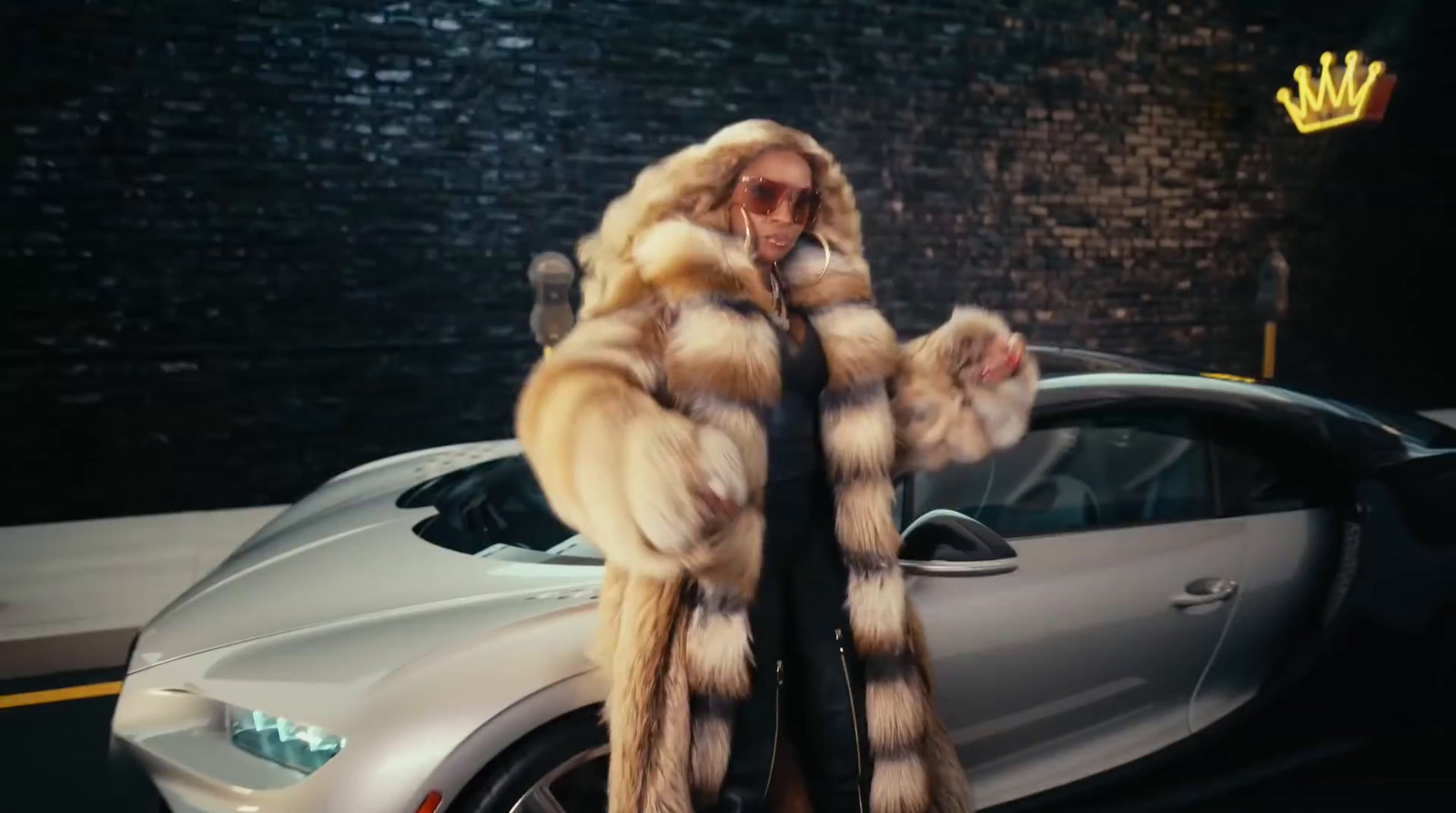 a woman in a fur coat standing next to a car