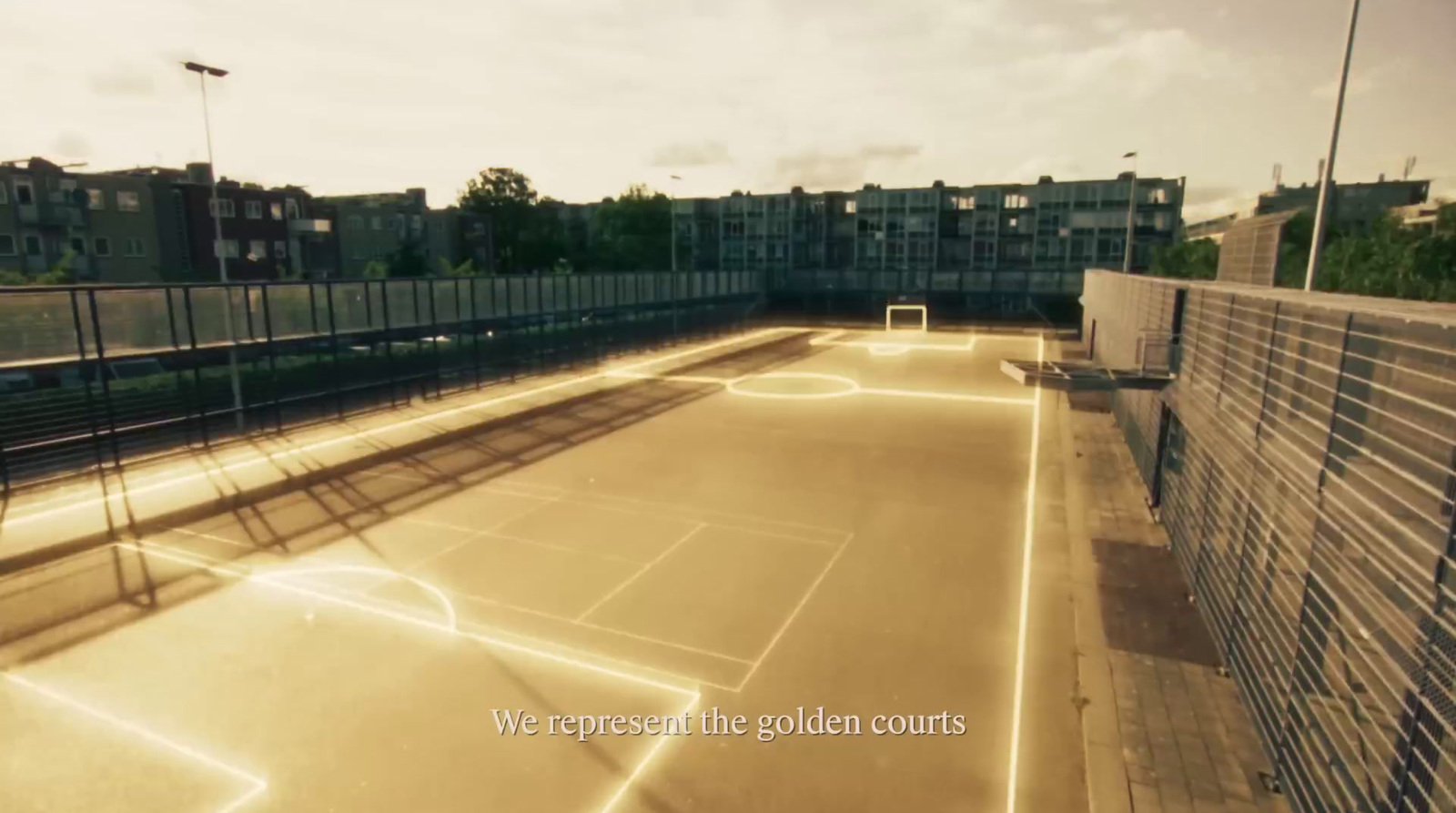 a tennis court with lights on the side of it