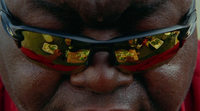 a close up of a man wearing a pair of sunglasses