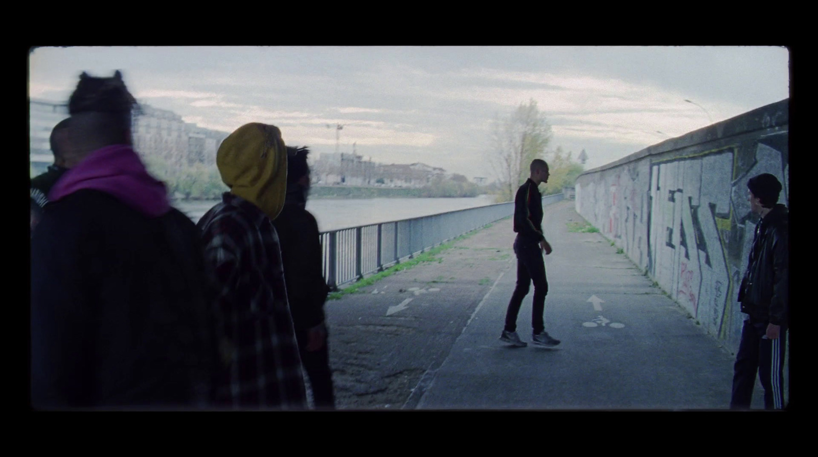 a man riding a skateboard down a sidewalk