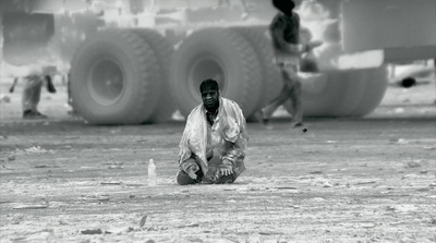 a man kneeling down in front of a truck