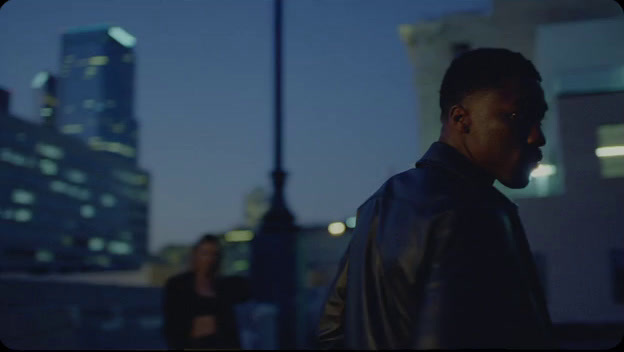 a man standing in front of a tall building