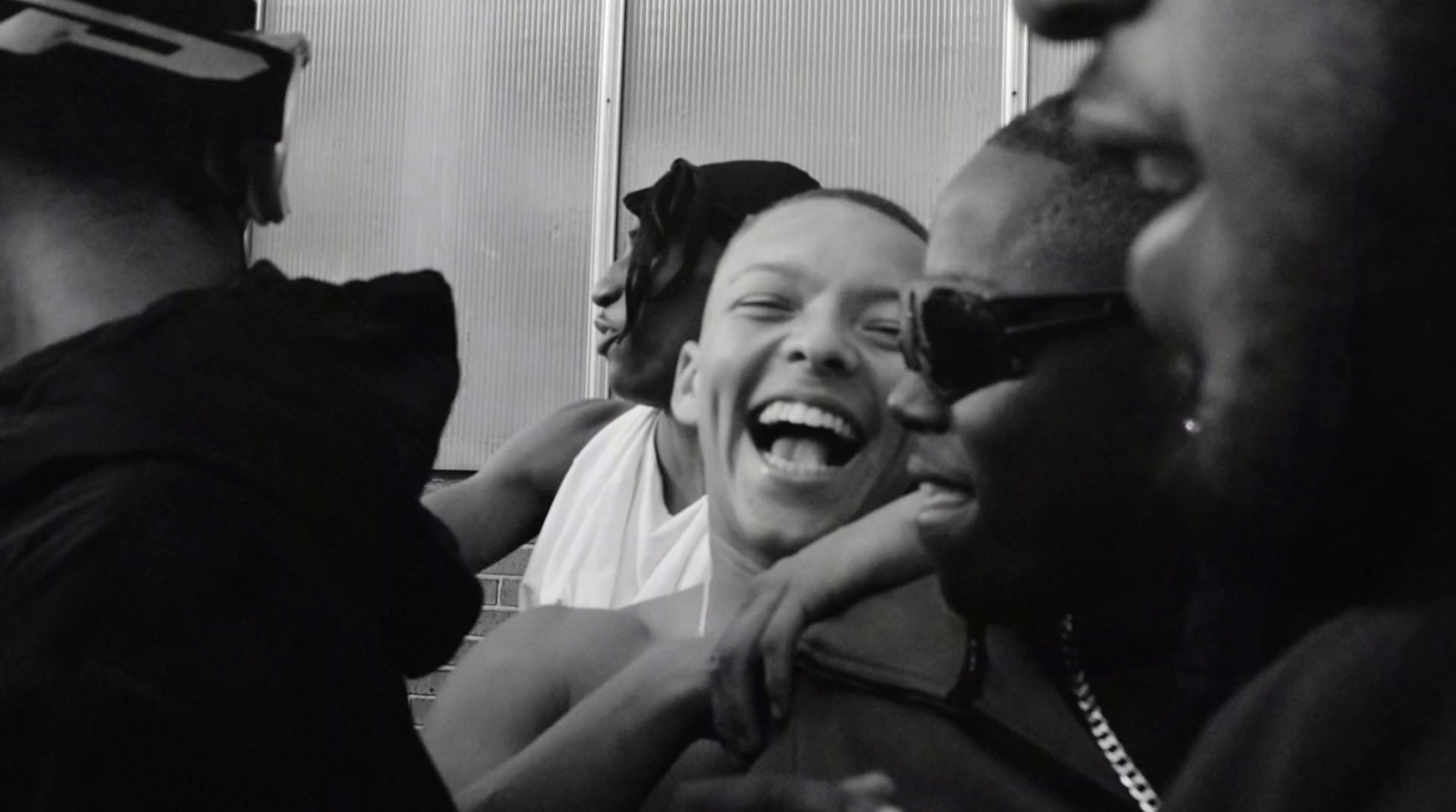 a black and white photo of a group of people laughing