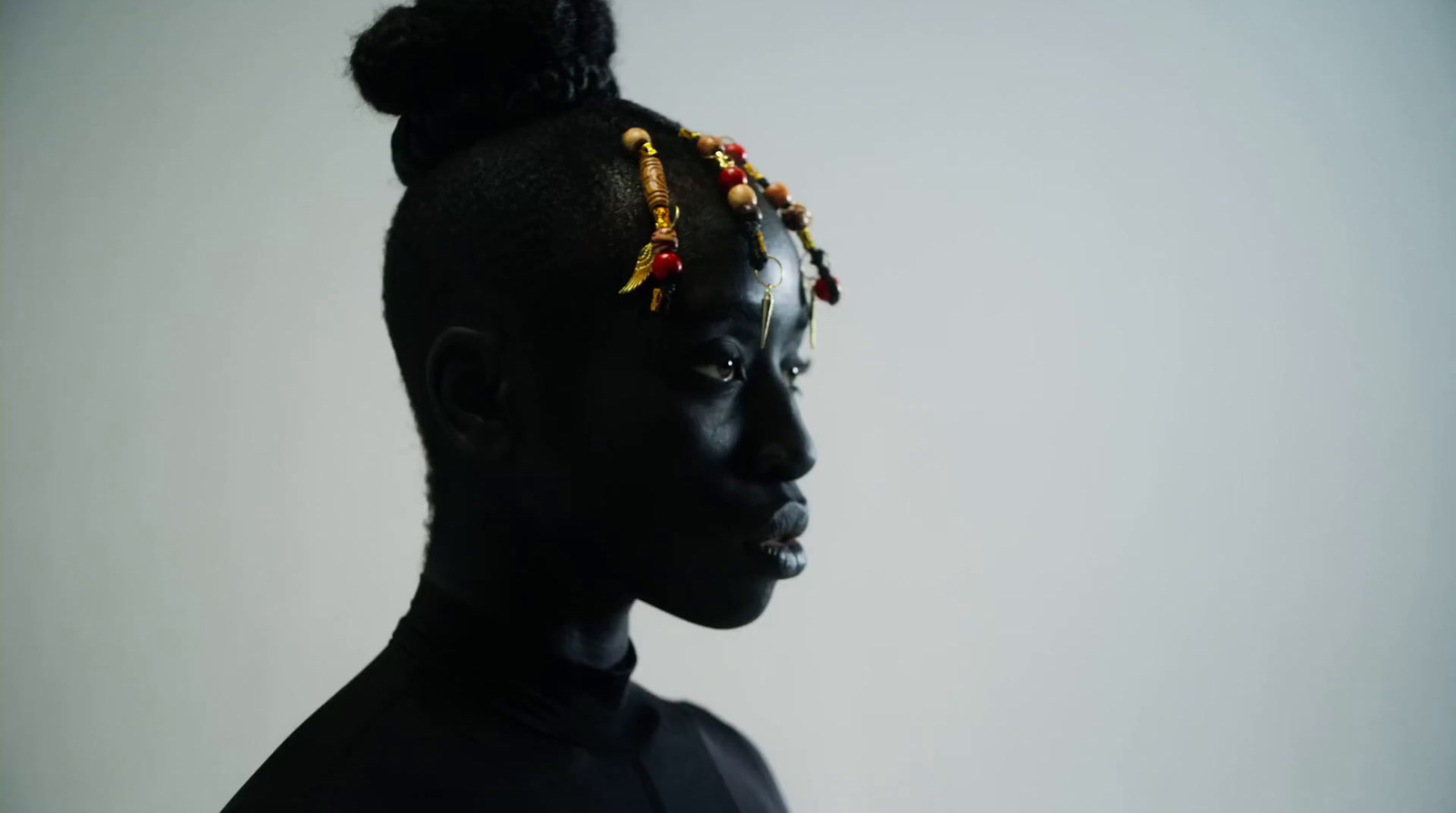 a woman with a bun with beads on her head